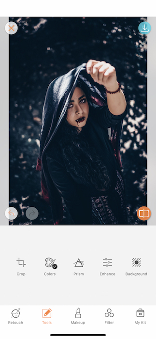 Picture of a woman holding a scarf up her head being edited by Airbrush