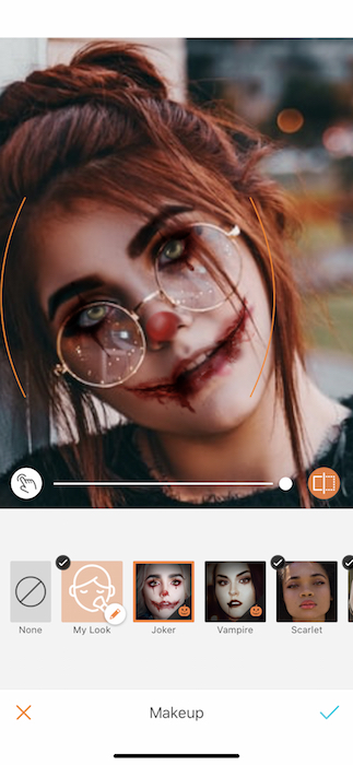 A woman with red hair with a book open being edited by Airbrush with the Joker Makeup