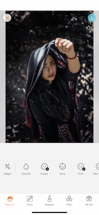 Picture of a woman holding a scarf up her head being edited by Airbrush