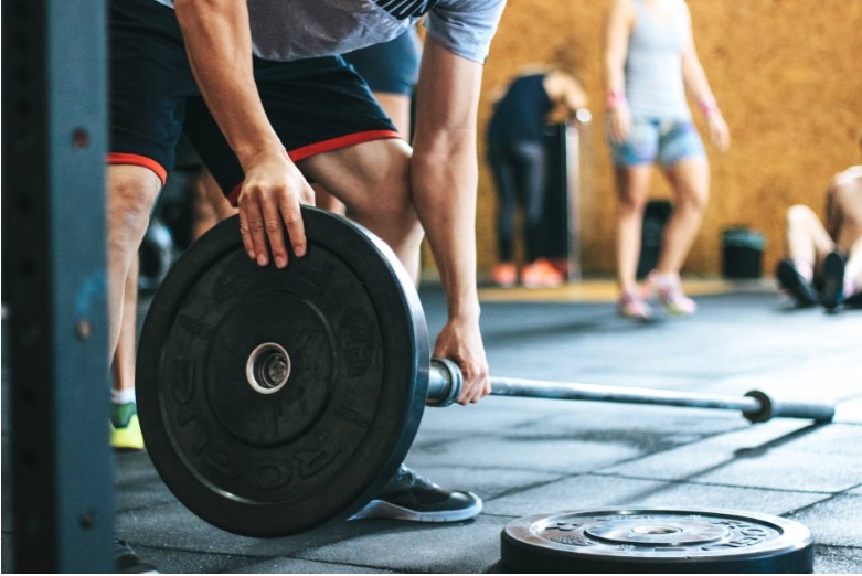 man adjusting weights